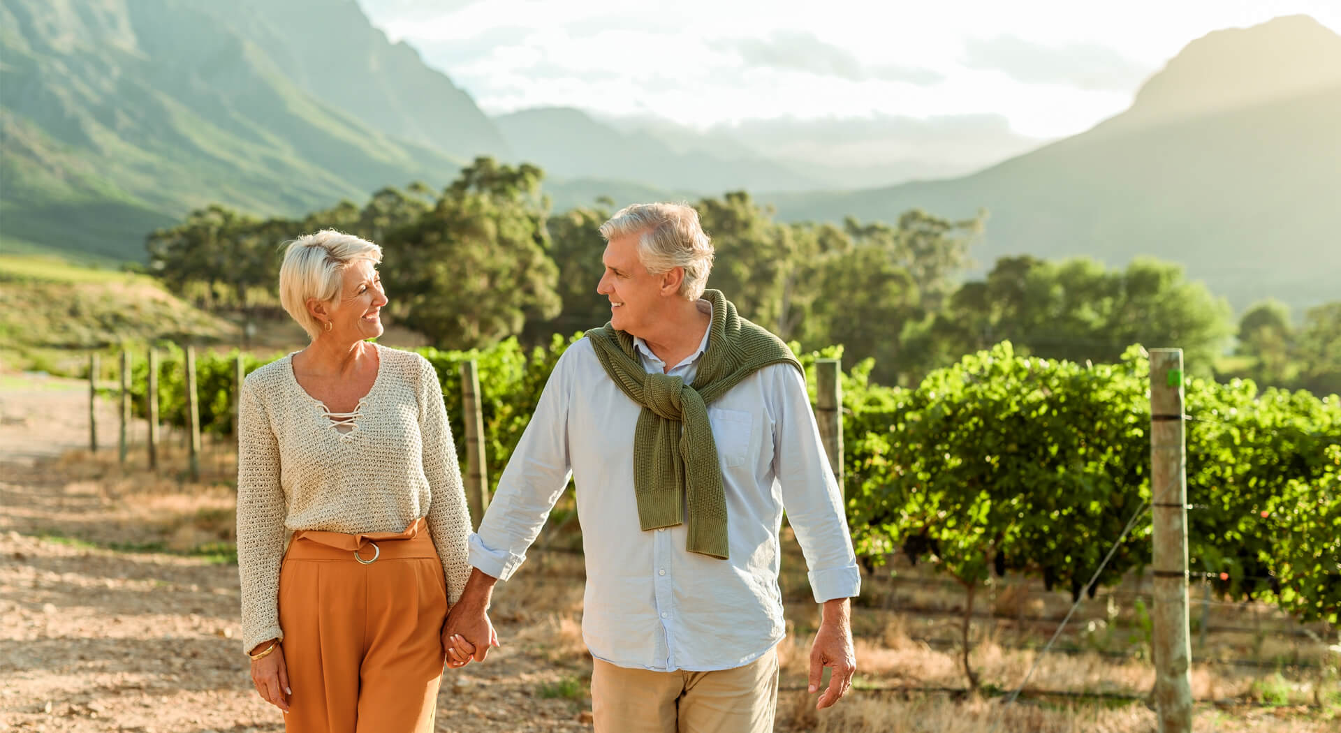 services senior couple walking on a wine farm